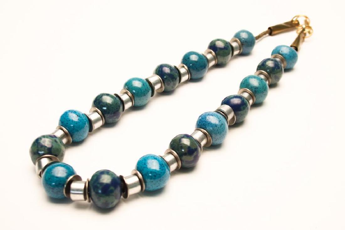 Doyle Lane MCM Studio Pottery, Multi-Bead Necklace: Measures approx. 27 inches. Multi Bead Necklace designed and constructed by Doyle Lane (20th Century, California). Includes 17 beads separated by steel washers and aluminum tubing. Ends are made from 