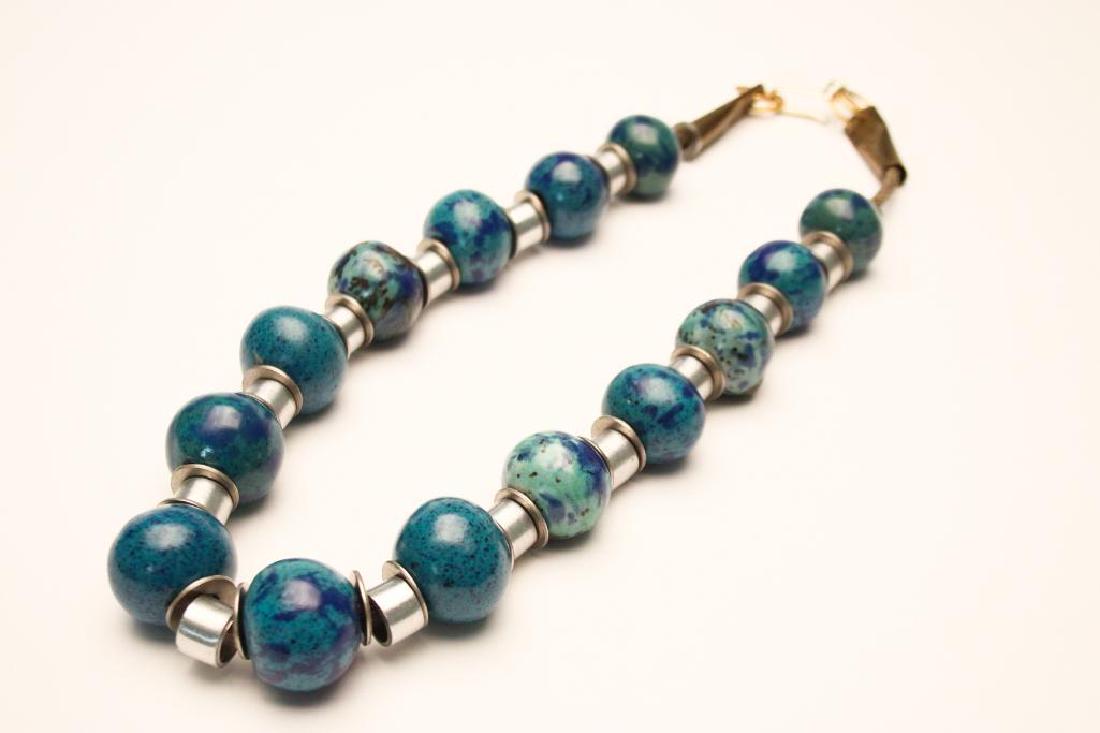 Doyle Lane MCM Studio Pottery, Multi-Bead Necklace: Measures approx. 24 inches. Multi-bead necklace designed and constructed byÊDoyle Lane (20th Century, California). Includes 14 beads separated by steel washers and aluminum tubing. Ends are made from