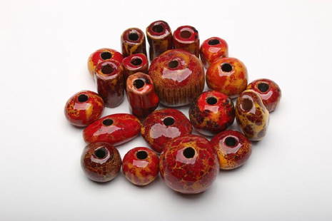 Doyle Lane 20 Red Art Pottery Beads: Doyle Lane (American, 1925-2002). Approximately .5-1.25 in. H x .625-1.375 in. W x .625-1.375 in. D each.