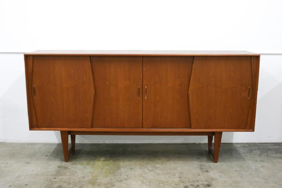 Danish Modern Teak Wood Credenza: Four sliding doors, interior fitted with drawers and shelves. Approx. 86.5 in W x 18 in D x 43.25 in H.