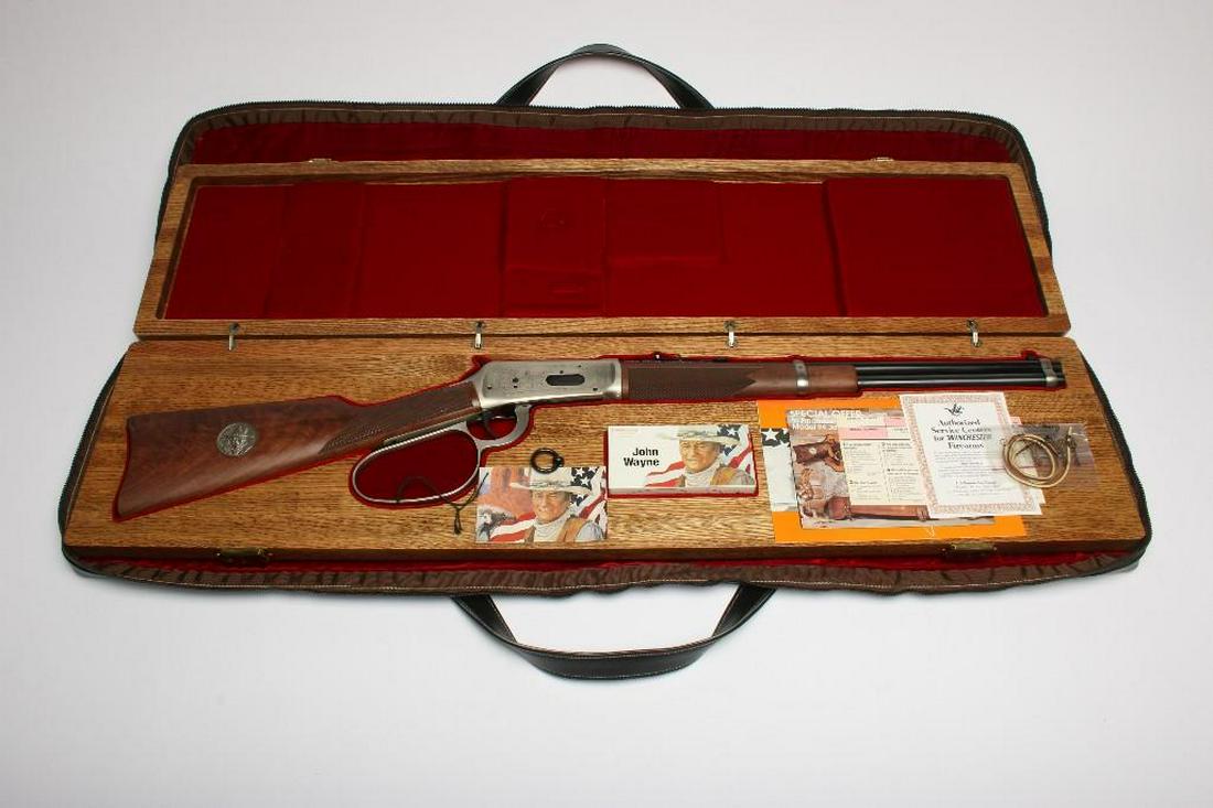 John Wayne Commemorative Winchester Rifle Model 94: Model 94. Serial #JW21853. Approx. 36 inches. Includes oak presentation box, paperwork, cartridges, leather strap, keys, and red felt lined vinyl storage bag. All sales must go through a FFL broker.