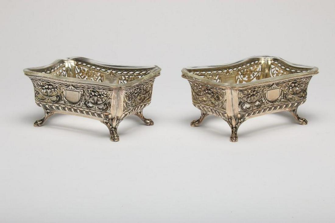 Pair Antique Lazaruz Posen Silver Footed Basket: Pierced Silver Footed Baskets. Includes glass inserts. Antique German silver baskets. Stamped 800 and hallmarked Lazaruz Pozen. Each approx 7 in x 5 in x 3 in H.