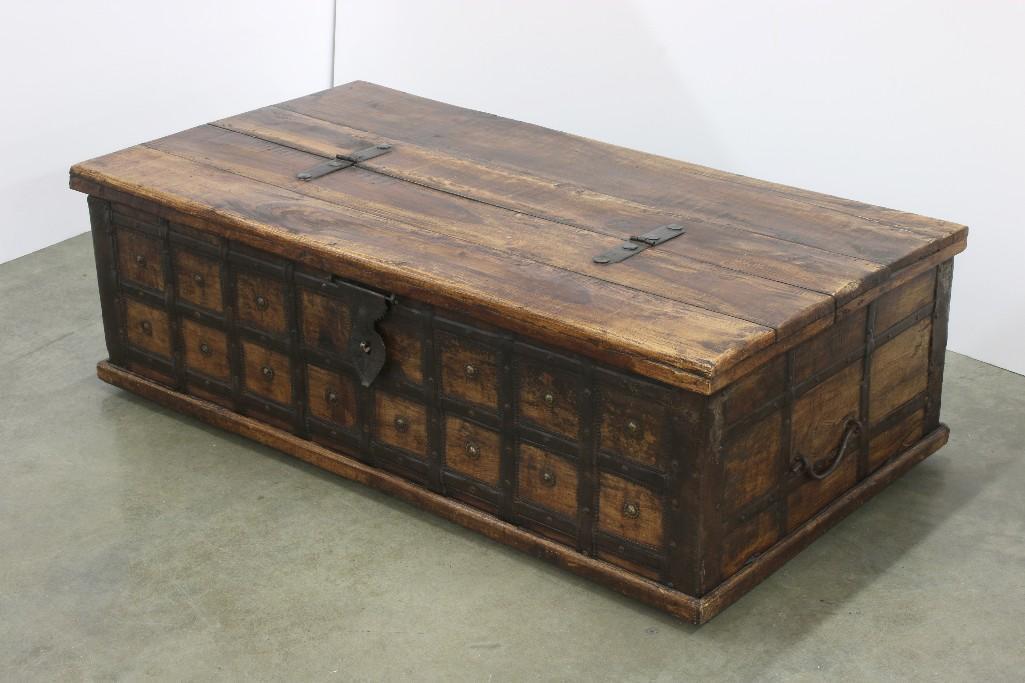 Contemporary Imported Chest with All-Over Iron Hardware: Approx. 49 in. L x 26.5 D x 16.25 T. Hinged top opens for storage. Hand wrought iron decorative hardware.