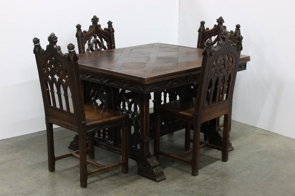 Spanish Gothic Revival Dining Table and 4 Chairs: Closed, table measures 48 in L x 39.25 W x 30 H. Approx. 84.25 L with leaves extended. Chairs measure 40.25 in. H x 17 W x 18.75 D. Hand carved oak table with parquet inlay top and six side chairs.