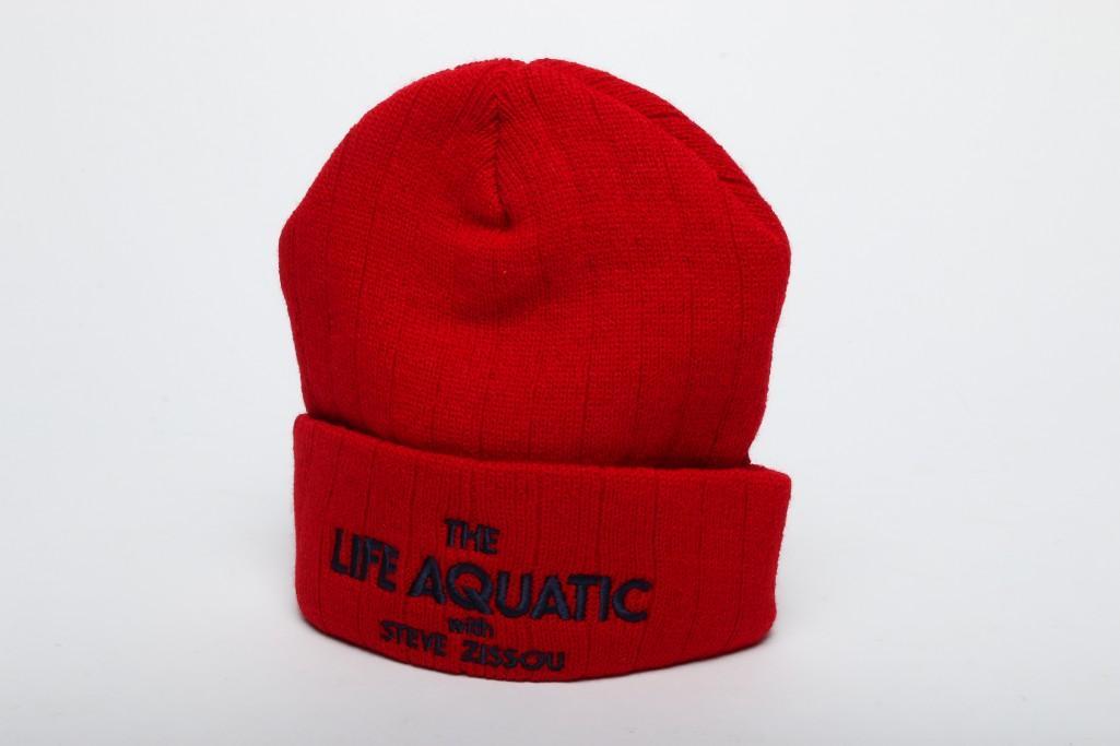 The Life Aquatic with Steve Zissou (2004) Beanie Hat: Approx dimensions: 7.5 in H x 7 in W. Red beanie with film title on front and traffic light on back. From the Touchstone Pictures production of Life Aquatic with Steve Zissou starring Bill Murray, Owe