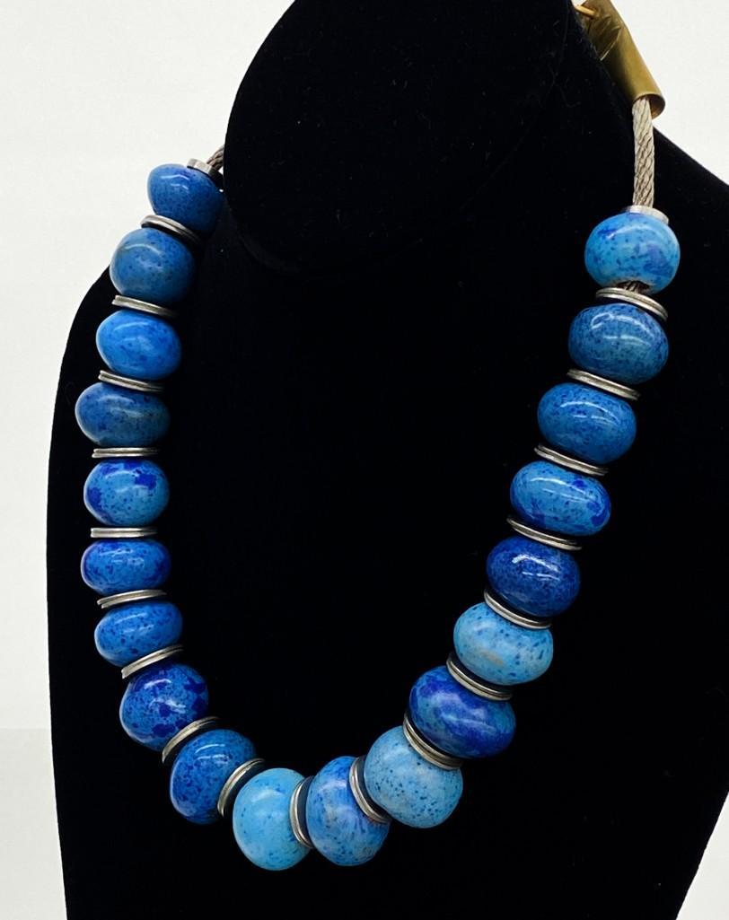 Doyle Lane (1925-2002) Ceramic Blue Bead Necklace: Original Doyle Lane (1925-2002) Ceramic Blue Bead Pottery Necklace. 19 beads. Approx dimensions: 20 in W x 1 in H. Weight: 7 oz. Multi Bead Necklace designed and constructed by Doyle Lane. Includes 19