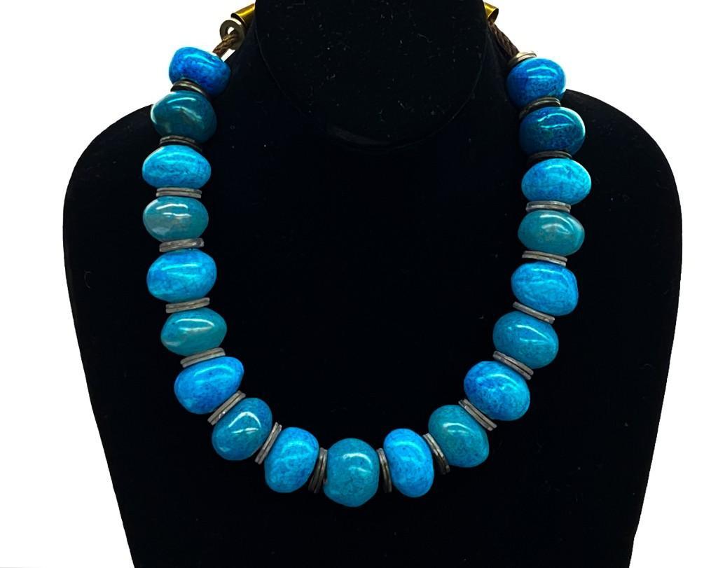 Doyle Lane (1925-2002) Ceramic Blue Turquoise Necklace: Original Doyle Lane (1925-2002) Ceramic Blue Turquoise Pottery Necklace. 19 beads. Approx dimensions: 20 in W x 1 in H. Weight: 7 oz. Includes 19 beads separated by steel washers. Ends are made from b