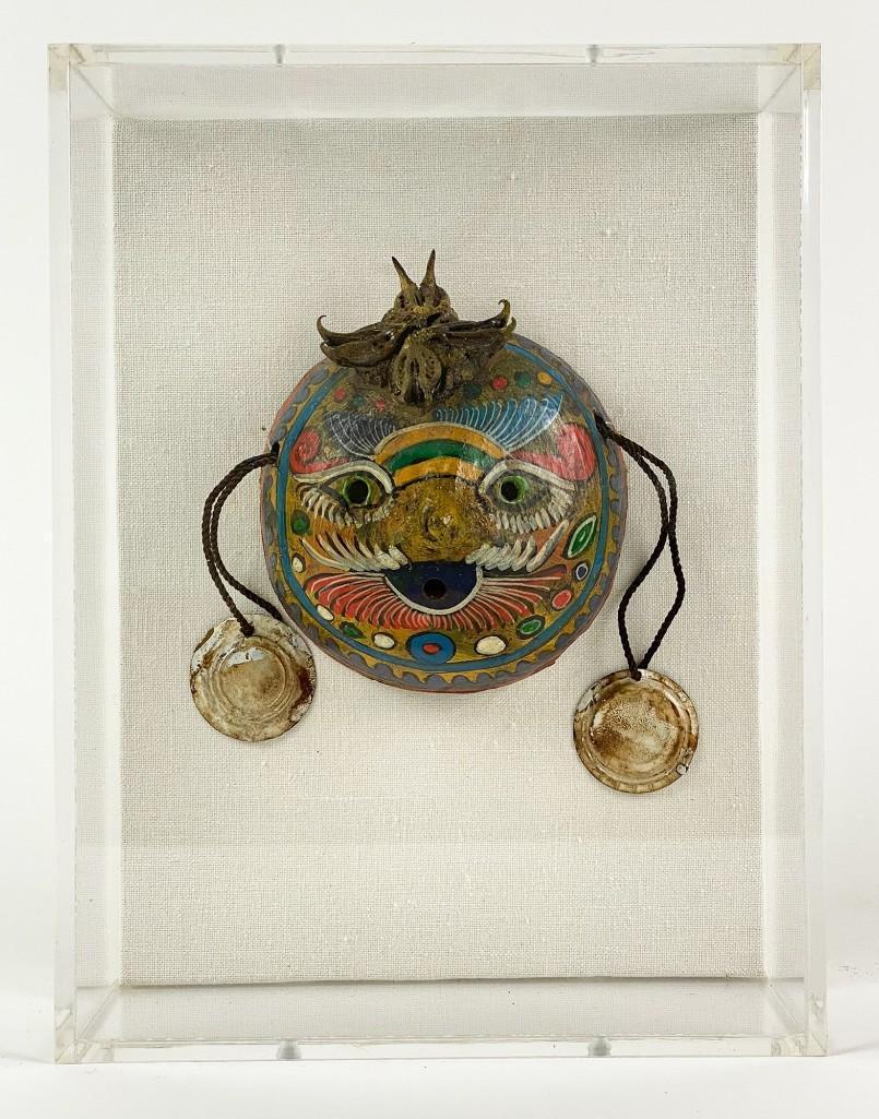 Coconut Shell Mask in Lucite Shadow Box: Approx. dimension: frame: 10.5 in H x 8 in W x 3.75 in D; mask: 5.5 in W x 4.5 in H. Hand painted mask made from coconut shell with earrings and seed pod crown. Encased in Lucite shadow box frame. Wei