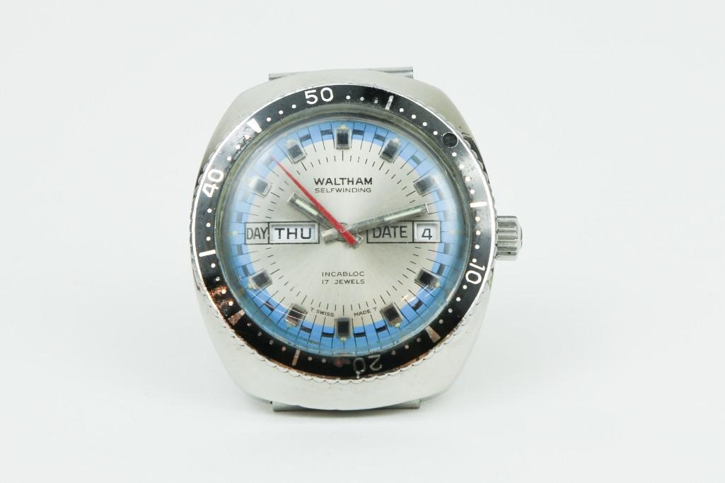 Vintage Waltham Day Date Diver Wrist Watch: Self winding 17 jewel movement. Model 908. Stainless steel case with blue face and black markers. Case approx. 37.3 mm with metal band.
