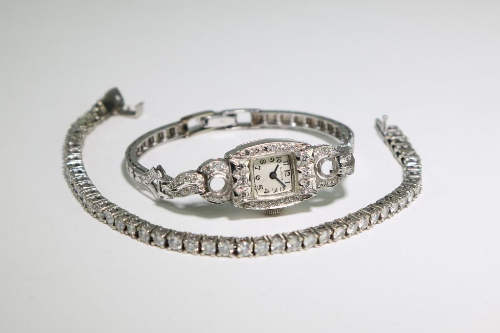 14K Diamond Glycine Watch & Platinum Diamond Bracelet: 14K White Gold Glycine Swiss ladies wristwatch 6 inches long. Watch weighs 21.3 grams. Platinum and Diamond Tennis bracelet 6.75 inches long. Tennis bracelet weighs 12.8 grams.