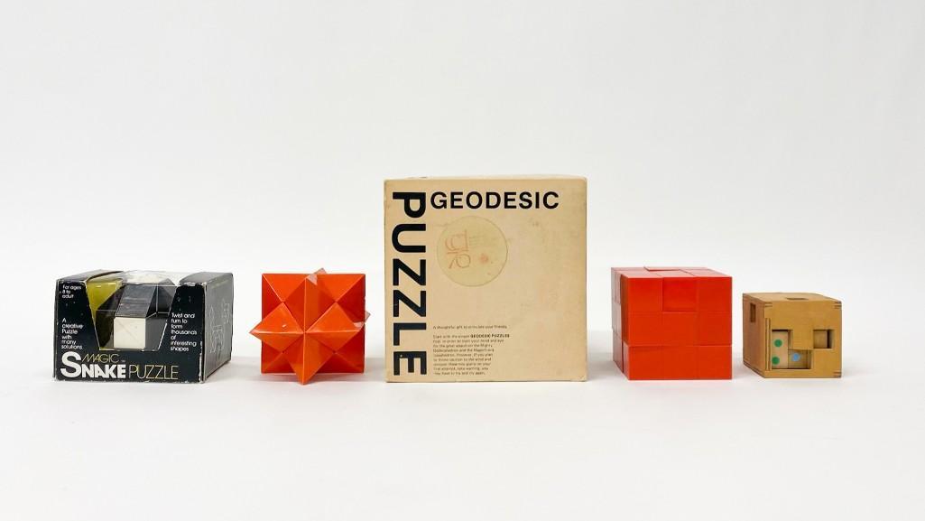 Group of Five (5) Vintage Puzzles: Group of Five (5) Vintage Puzzles Including Geodesic Puzzle Model Number 8-350, Magic Snake Puzzle, Orange Plastic Star Puzzle, Cube Puzzle, and Wooden Cube Puzzle. Overall: approx. 2.5 to 6.5 in. Wei