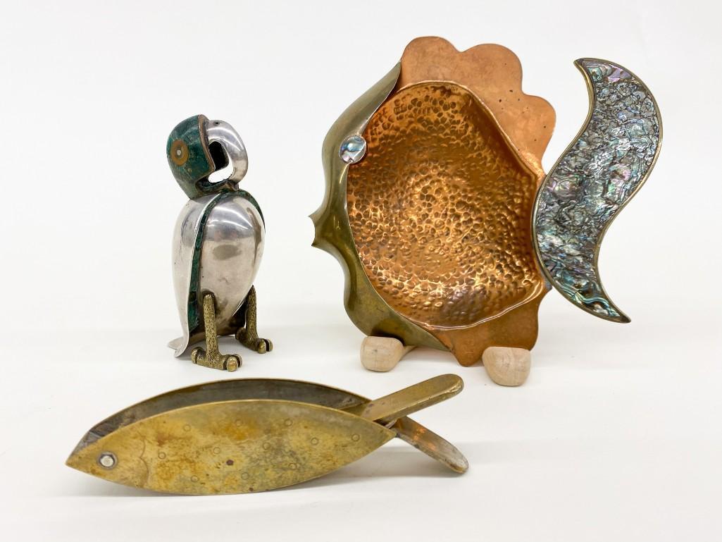 Group of Three (3) Vintage Brass / Copper Accessories: Group of Three (3) Brass/Copper Accessories. The hammered copper fish with mother of pearl inlays is an ashtray, the other fish might be a nutcracker(?) and the bird is a salt shaker. His head and und