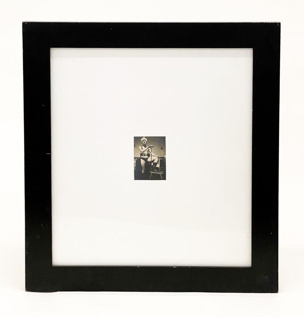 Framed and Matted Snapshot Depicting Young Man: Framed and Matted Snapshot Depicting Young Man in Underwear. A very strange/ silly/ somewhat erotic pose in improvised costume. Possibly a military barracks or boarding school setting. Visible: Approx