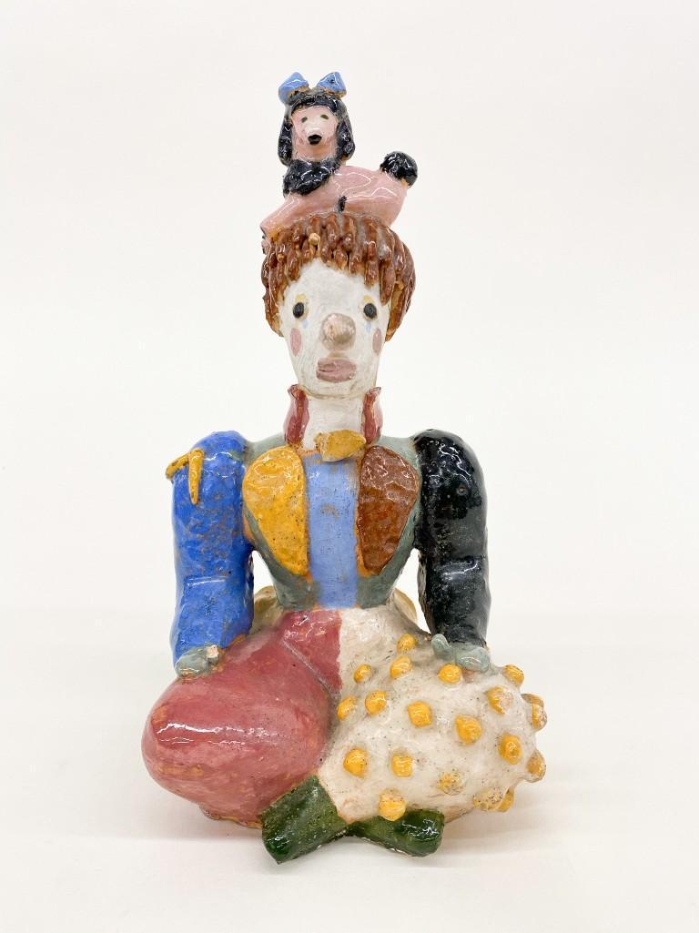 Glazed Ceramic Clown Figure: Unsigned. Glazed Ceramic Clown Figure. With a pink poodle atop his head. Approx. 9.5 in. x 5 in. x 5 in. Weight 2 lbs. 9 oz.