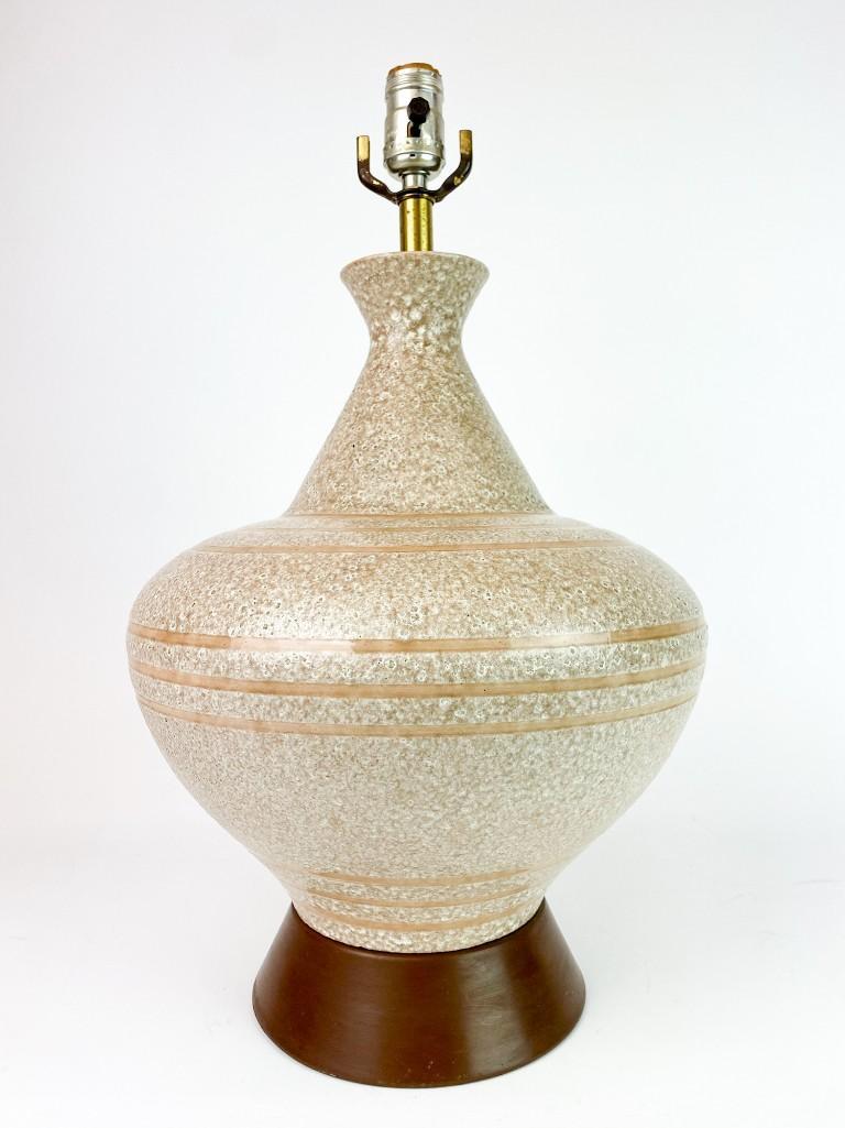 Oatmeal Volcanic Lava Glaze Vintage Mid Century Lamp: Oatmeal Volcanic Lava Glaze Vintage Mid Century Table Lamp. Adds an elegantly minimalist Mid Century flair to any space. Approx. dimensions: 20 in. H x 12 in. W. Weight: 6.6 lbs.