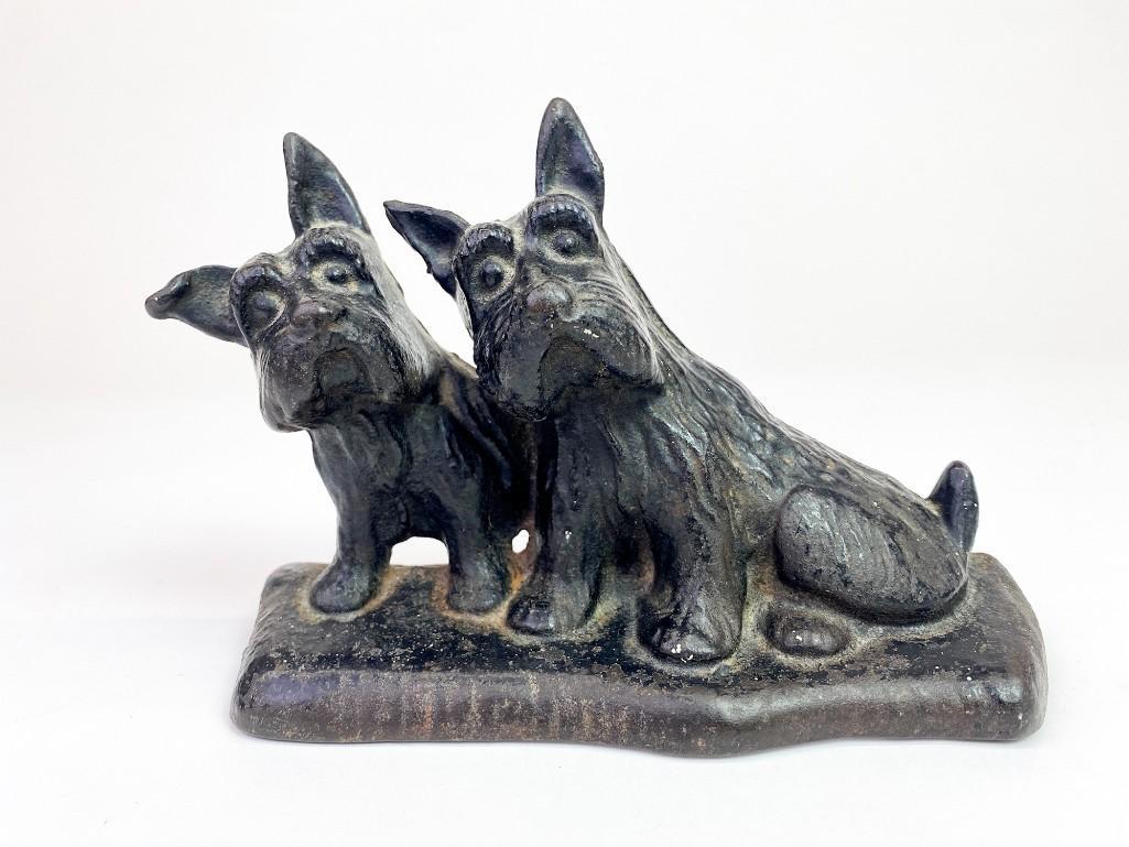Cast Iron Figure of Two Scottish Terriers: Cast Iron Figure of Two Scottish Terriers. Light surface wear. Has a â€œ0” stamp. Approx. dimensions: 5.5 in. H x 9 in. W x 3 in. D. Weight: 3.7 lbs.