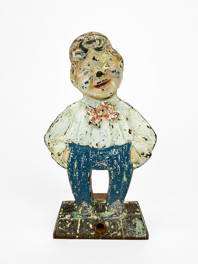 Vintage Painted Cast Iron Dapper Boy Figurine: Vintage Painted Cast Iron Dapper Boy Figurine. Wear commensurate with age. Surface wear/ paint chipping. Approx. dimensions: 7 in. H x 4 in. W. Weight: 1.4 lbs.