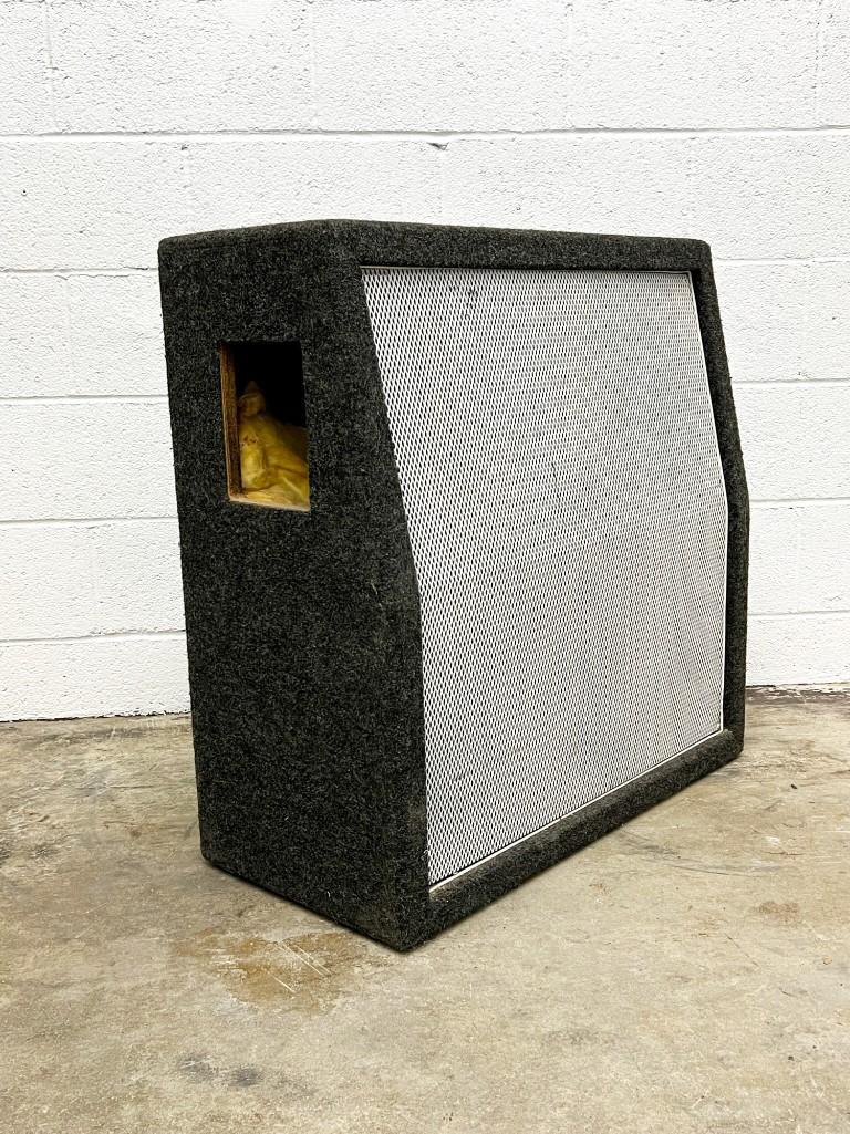 Carvin V412T Slanted Speaker Cabinet: Carvin V412T Slanted Speaker Cabinet. This 400w, 8 ohm cabinet houses four 12 in. speakers and has two 1/4 in. inputs. The grey carpet wrapping is in good condition with no stains or tears. The recess