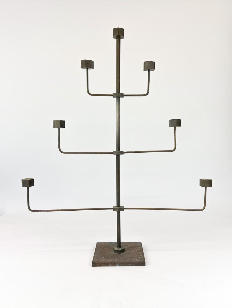 Folk Art Brass Nut Candelabra: Folk Art Brass Nut Candelabra. Brass candelabra. Brass with age patina. Scuffs and scratches throughout. Approx. 31.625 x 27 x 7.125 in. Weight 8.65 lbs.