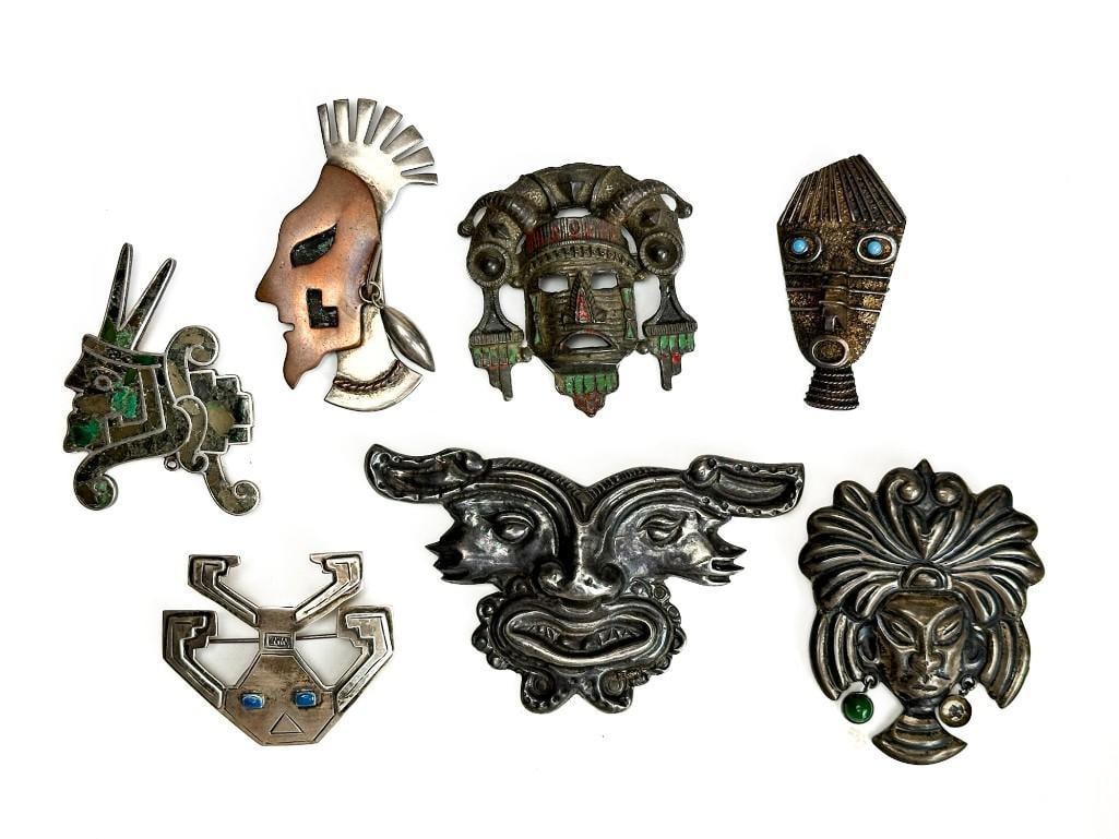 Lot of 7 Various Tribal Mask Brooches: Lot of 7 Various Tribal Mask Brooches. Peru, Taxco, Mexico, Ecuador, and others. Some unmarked. Condition as pictured. One missing stone.