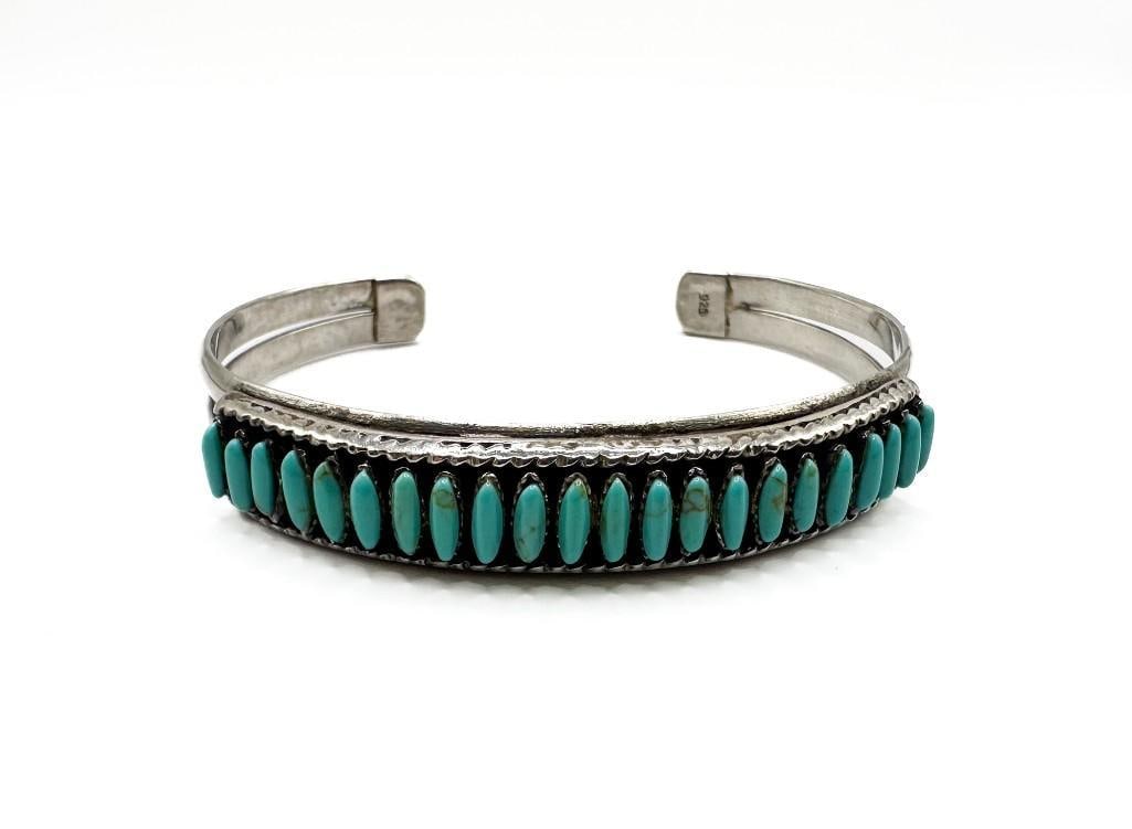 Nick Chavez Collection: Zuni Snake Eyes Turquoise Row Cuff Bracelet: Nick Chavez Collection: Zuni Snake Eyes Turquoise Row Cuff Bracelet. Good condition. Stamped 925. Approx. 2.5 x 2 x .5 inches. Weight 24.4 grams. Interior is approx. 5.5 in. with 1 1/8 in. gap.