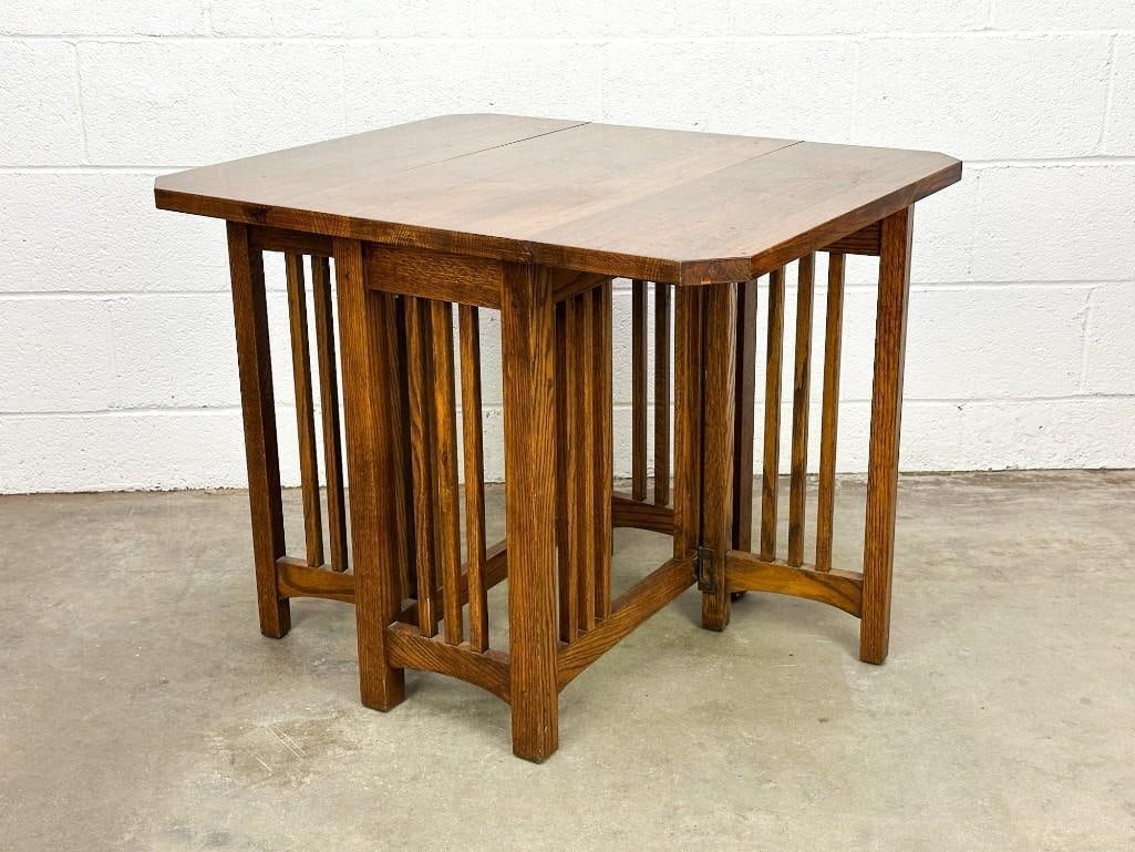Arts & Crafts Drop Leaf Table: Features two-sided drop leaves allowing for easy storage. Condition: Very good condition with extremely minimal surface wear. Dimensions: Folded: 25.5 in H x 26.5 x in W x 15 in D. Unfolded: 25.5 in H