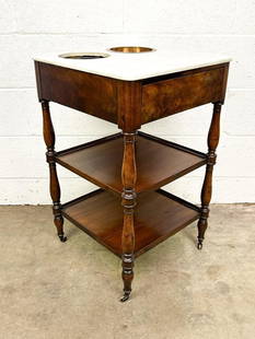 Antique French Marble Plant Stand: White marble top with two holes. One copper pot. 2 shelves.  Condition: Some light surface wear throughout. Bottom shelf has split. Some minor damage on veneer. One copper pot is missing.  Dimensions: