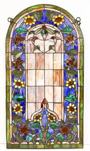 Reproduction Stained Resin Arched Window Panel with Sunflower Motif: Made of dyed resins. Metal frame. Includes chains for hanging.  Condition: Good condition. No visible chips, breaks, or cracks.  Dimensions: Approximately 26.5 in H x 14 in W. Weighs approximately 6 l