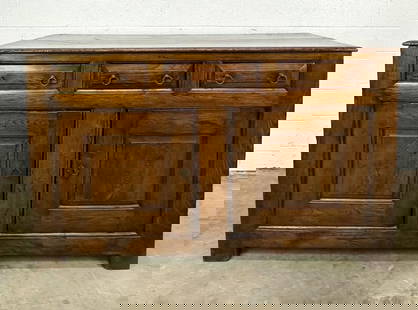 Antique English Oak Cabinet Buffet w/ 3 Drawers: 3 drawers and lower cabinet. Drawers are felt lined for silverware. Ring pulls.  Condition: Some surface wear and scuffs throughout. Minor warping and cracks on right side of top. 1 in chunk of wood i
