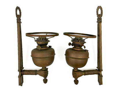 Pair Antique Brass Oil Lamp Sconces: This is a metal pair of vintage oil lamp sconces.?   Condition: Some oxidation. Minor scuffs and surface wear throughout. One lamp is slightly bent. See photos.   Dimensions: Each sconce is approx 18.