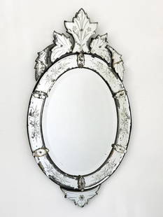 Venetian Oval Mirror w/ Engraving & Floral Design: Antique mirror with engraved glass floral designs.  Condition: Some cracks. Reflective material behind glass has flaked off in some areas.  Dimensions: Mirror is approx. 38 in H x 20.5 in W x 1 in D.