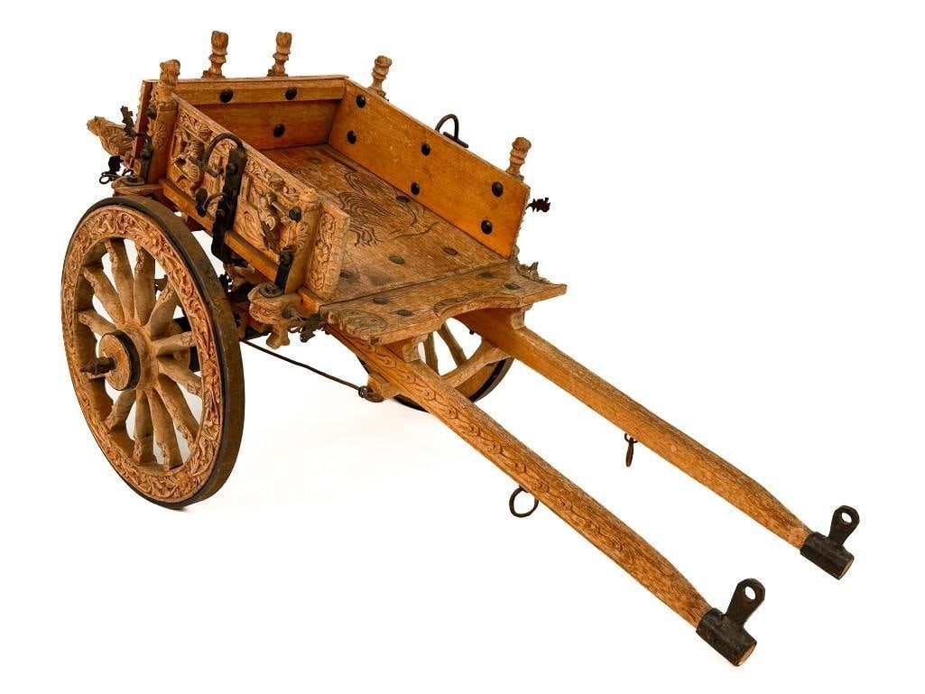 Antique Carved Wood and Metal Sicilian Miniature Cart: Cart is ornately carved with floral and figurative motifs. Metal hardware. Condition: Good condition. No visible cracks, chips, or breaks. Some metal ornamentation is distorted. One head is missing fr