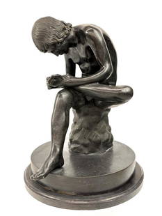 Vintage Bronze Spinario Sculpture: Nude boy pulling a thorn from his foot. Bronze sits on a marble slab. Fig leaf is removable.  Condition: Good condition. Two quarter inch chips to the marble base. Sculpture is not attached to the mar