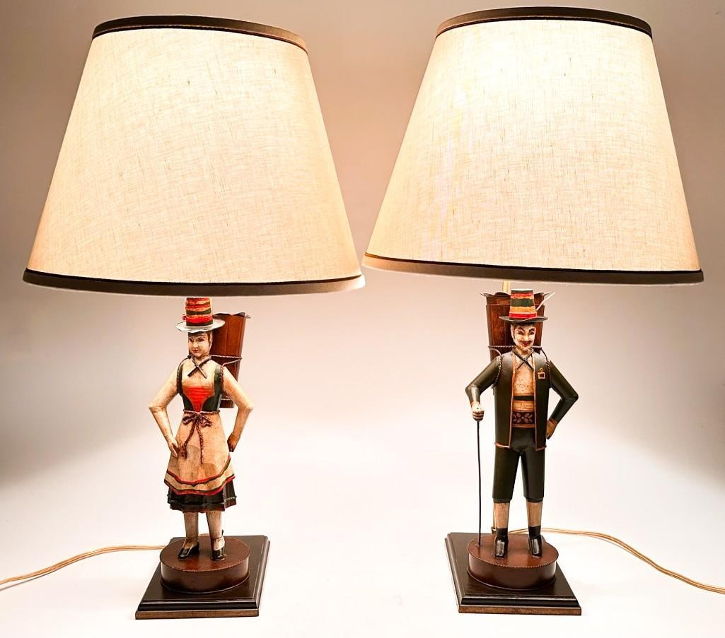 Pair of Vintage Tyrolean Tole Figural Lamps: Condition: Evidence of repair on the female figures ankles. Tested and in working condition. Dimensions: Each lamp is approximately 26.5 in H x 15 in W x 15 in D. Total weight is approximately 13 lbs