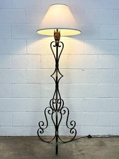 French Wrought Iron Floor Lamp: Floor lamp wrought iron base. Foot switch.  Condition: Some minor surface wear.  Dimensions: 67 in H x 21 in dia.