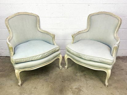 Pair Louis XV Style Upholstered Armchairs: Carving detail along wooden frames. Well aged patina throughout.  Condition: Upholstery has fading and light discoloration. Scuffs and wear along wooden frame.  Dimensions: Each chair is approx. 33.5