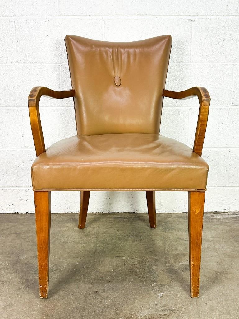 Vintage French Arm Chair w/ Tan Leather Upholstery: Leather upholstery with button in backrest. Condition: Good. Some wear throughout. Wear on armrest. Leather is loose. Dimensions: Chair is approx. 34 in H x 22 in W x 24 in D; seat: 17 in H.