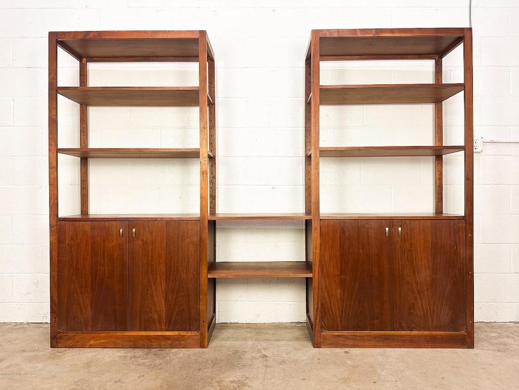 Midcentury Modern Etagere Shelving Wall Unit w/ Cabinets: Two shelving units with two shelves in between connecting them. Shelf height is adjustable. Condition: Some minor surface wear. Dimensions: Shelving unit is approx. 72 in H x 96 in W x 15 in D.