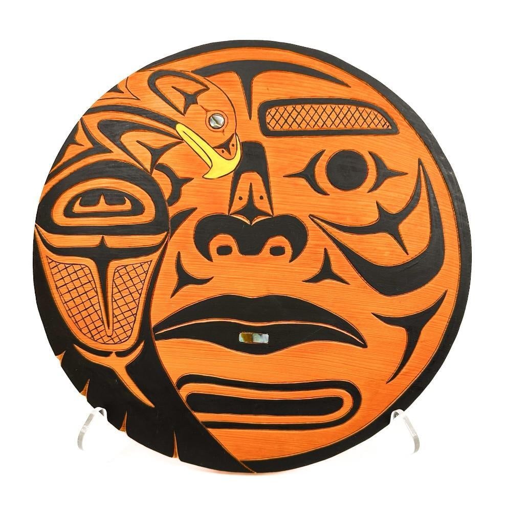 Alfred Crocker (b. 1950) Cedar Northwest Coast Carving with Pigment and Abalone Inlay, Eagle, Moon,: Titled Eagle, Moon. Signed on the back side. Coast Salish Carving depicting a face and an eagle with abalone inlay details. Condition: Good condition, light surface wear. Dimensions: Approximately 12 