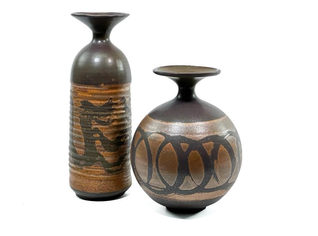 Two Large Designs West California Studio Pottery Stoneware Vessels: Includes both vases pictured. Condition: Excellent. Dimensions: One is approx. 12.75 in. H x 4.5 in. W and the other is 9.5 in. H x 7.5 in. W. Weight: 6.2 lbs.