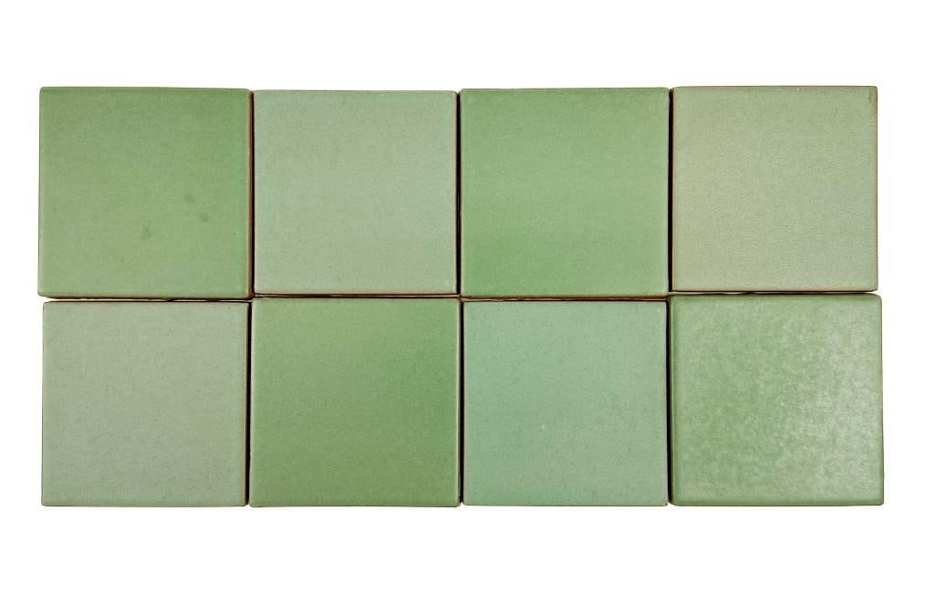 Large Lot of 50+ Vintage Matte Green Glaze Terracotta Tiles: Square tiles have a matte green glaze. Condition: Overall good condition. Some chips. Dimensions: Each tile is approximately 4 in H x 4 in W x 0.25 in D. Total weight is approximately 25 lbs. 