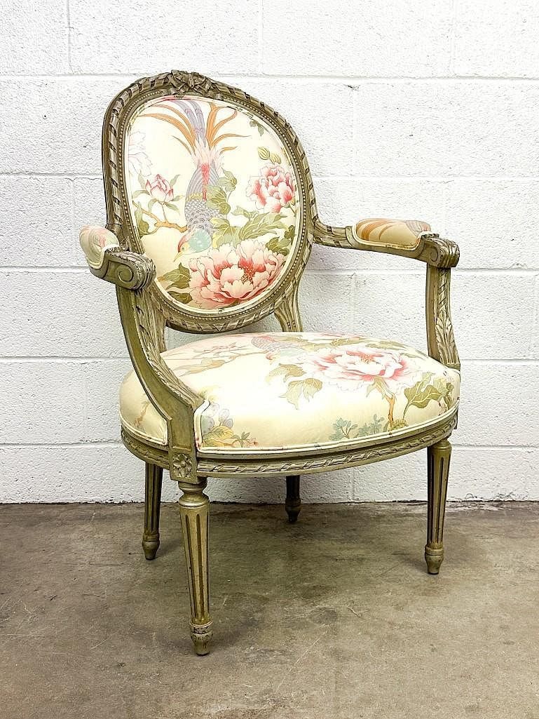 French Louis XVI Style Upholstered Armchair w/ Pheasant Bird Motif: French Louis XVI style armchair featuring fluted legs, carved frame, and floral upholstery with a pheasant bird motif. Approximately 37.5 H x 26.5 W x 23 D; seat height 17 inches.