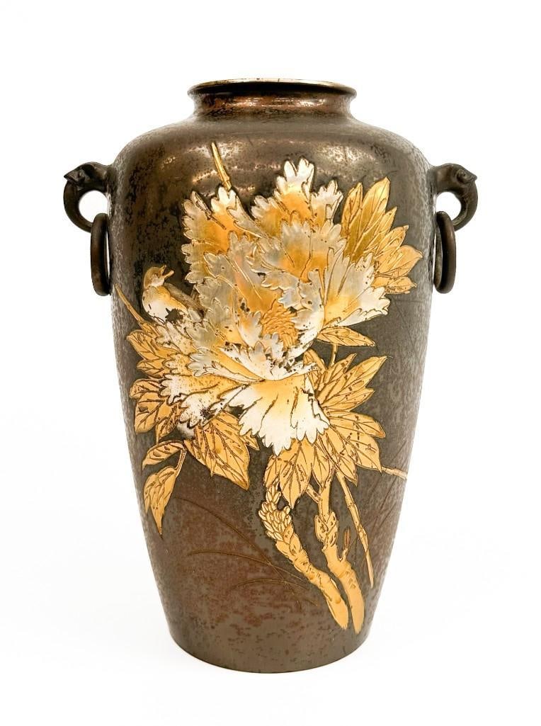 Japanese Antique Meiji Period Gilt and Painted Copper Metal Vase w/ Peony: Japanese Meiji period copper vase with gilt and painted repousse design of a bird and peony. Features decorative handles. Dimensions: 9.25 H x 6.5 W x 5 D inches. Weight: 2 lbs 9 oz.