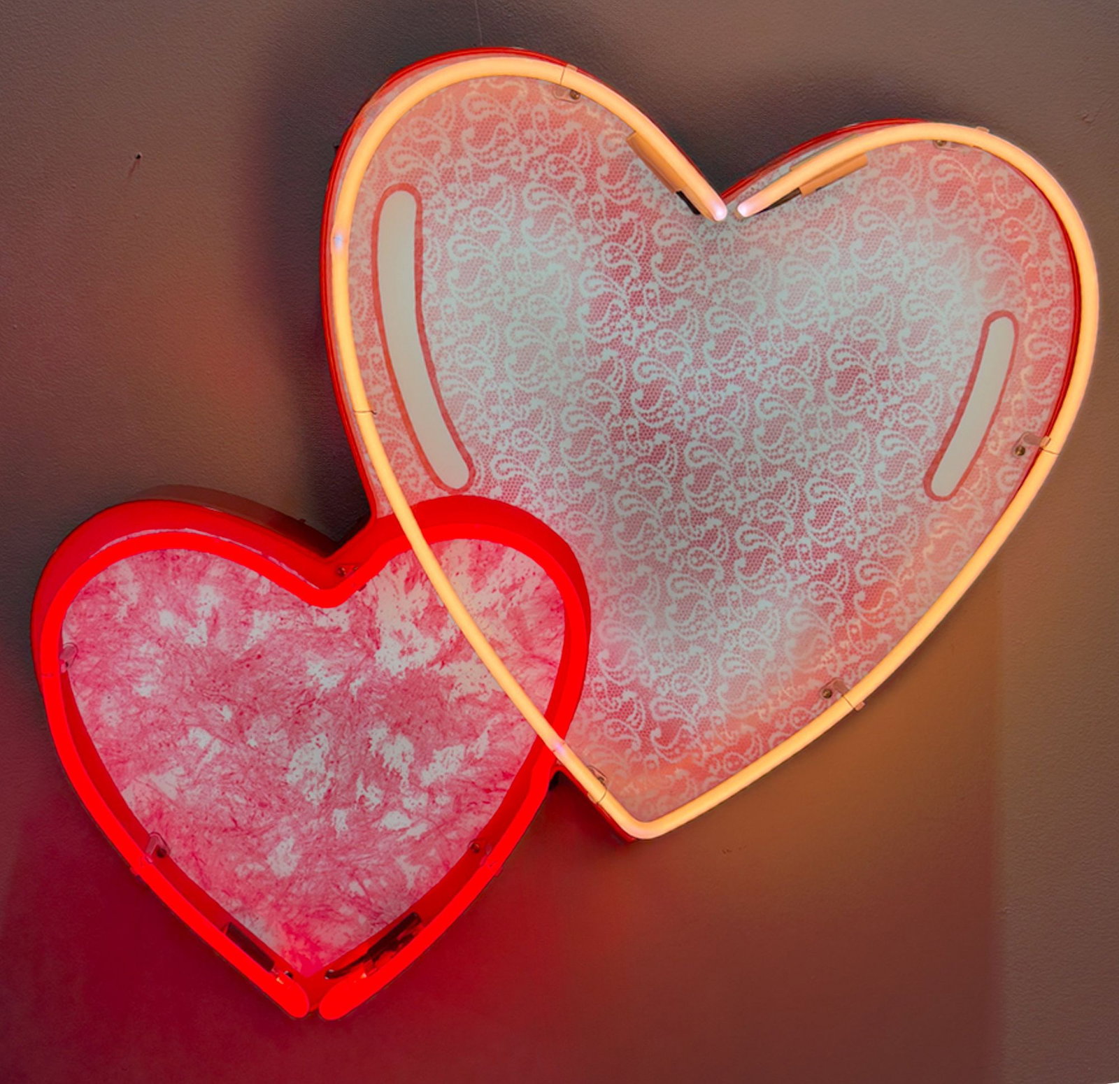 Two Hearts Vintage Inspired Neon Sign: Features two hearts with glowing outlines and intricate, backlit lace graphics. Plug and play. Film/Television Appearance: Used in TV show Wheel of Fortune Dimensions: 32" H x 34" W Backing