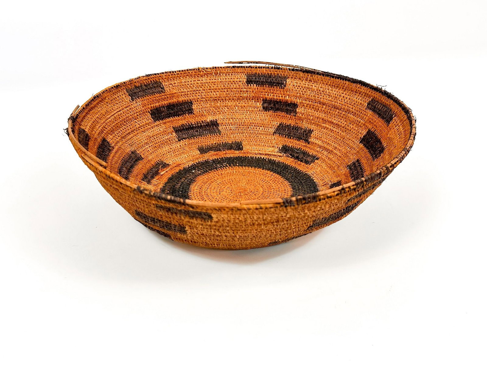 Soboba Coil Basket, Mid 20th Century, Southern California American Indian: Coil woven basket features source of water pattern in natural shades of indigo and brown. Approximately 3.25 in H x 11 in W x 11 in D. Weighs approximately 1 lbs.