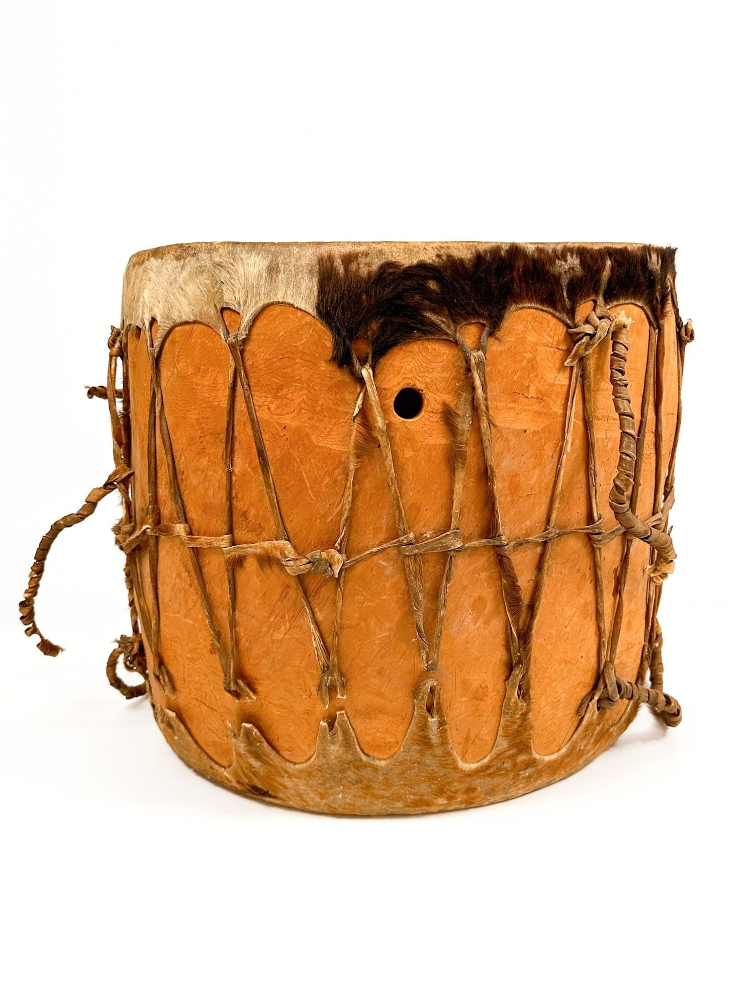 Cochiti Double Headed Drum and Beater, Early 20th Century, Southwest American Indian: Drum is made from a single piece of cottonwood trunk with steer hide stretched on both ends. Leather laced drum heads and handles. Comes with suede wrapped beater on a wooden handle. Approximately 17