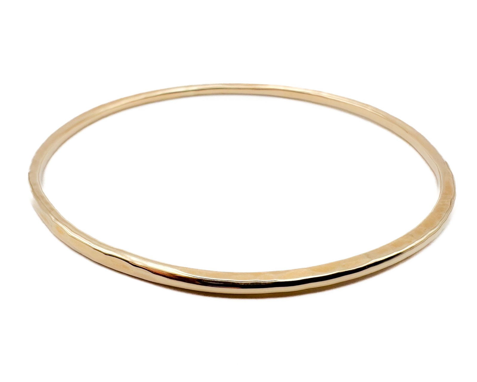 The Golden Bear 14K Yellow Gold Hammered Bangle Bracelet: 14K yellow gold bangle bracelet with a hammered finish. Marked 14K. Measures approximately 2.75 inches in diameter. Total weight: 13.5 grams.