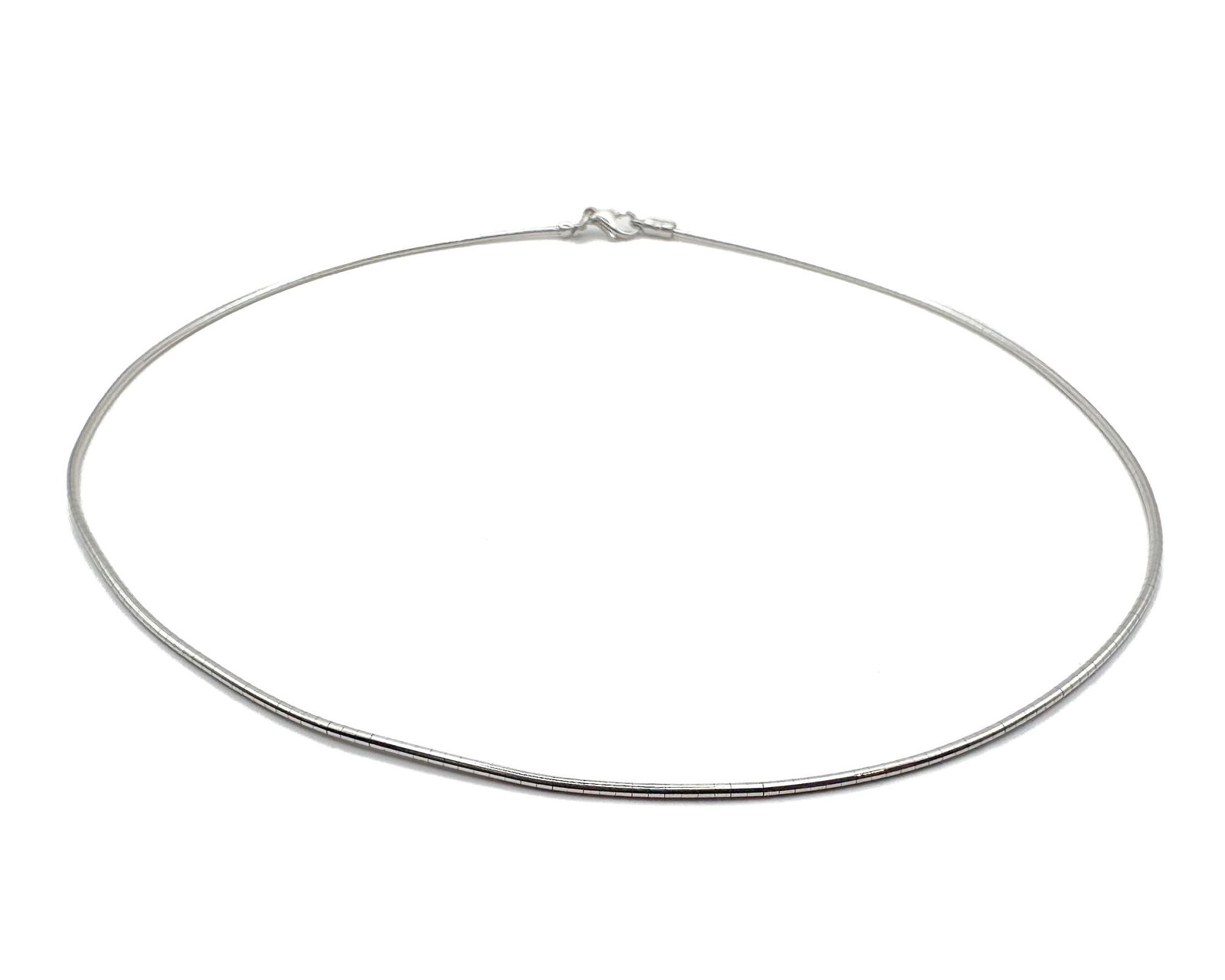 14K White Gold Omega Link Necklace, Italian Made: 14K white gold omega link necklace with sleek, flat design. Italian craftsmanship marked Italy. Dimensions: Measures 16 inches in length and approximately 0.0625 inches wide. Weighs 7.7 grams.