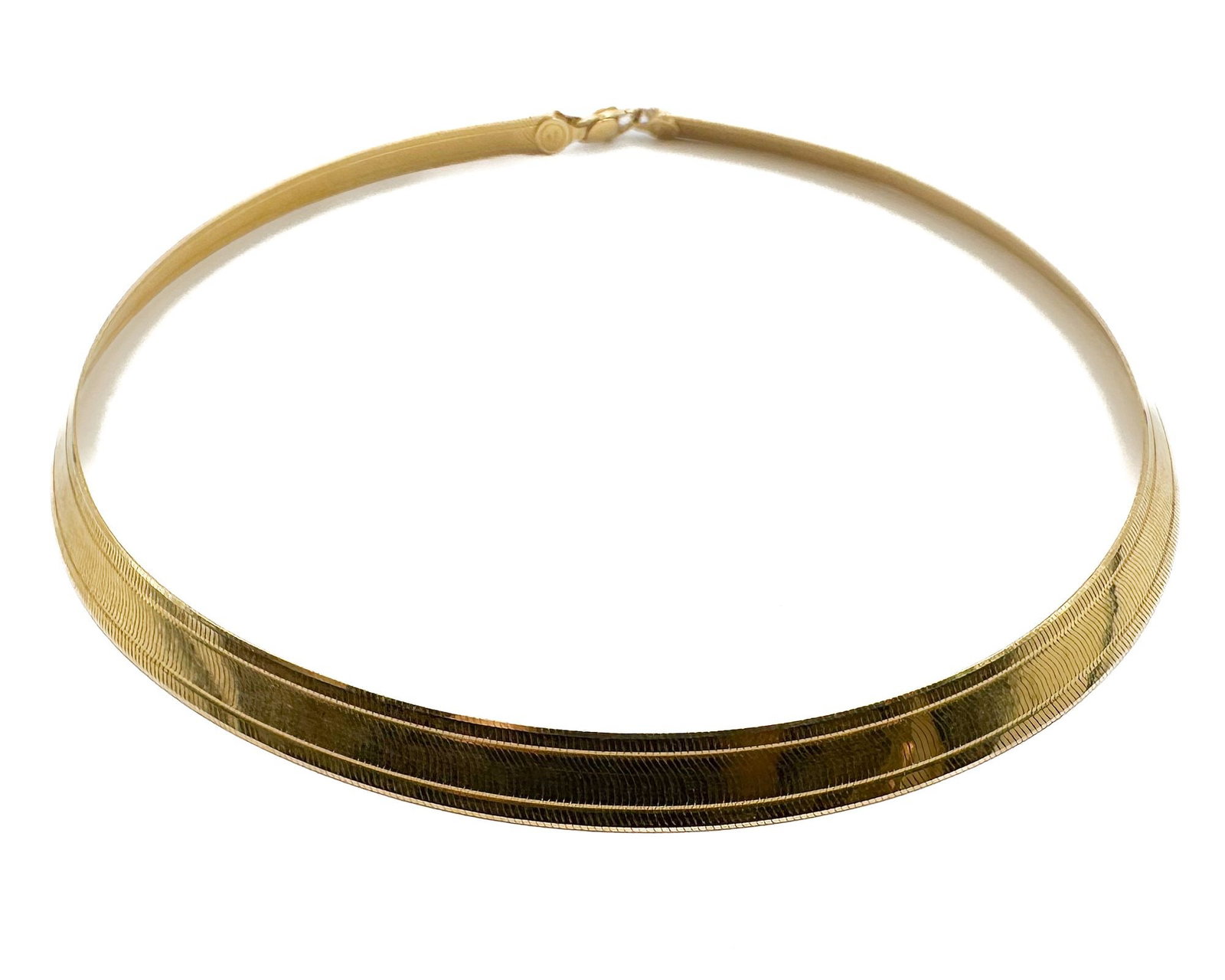 14K Yellow Gold Italian Omega Necklace: 14K yellow gold omega necklace with sleek design. Italian craftsmanship marked Italy. Dimensions: Measures 16 inches in length. Substantial weight of 27.5 grams.
