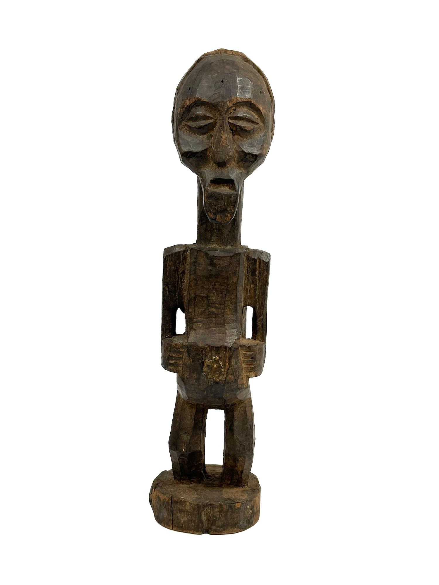 Songye Nkisi Figure, Southeastern Zaire, 20th Century: Carved wood.Dimensions: Approx 21 in H x 5 in W x 5 in D. Weight: 1 lb 13 oz.